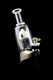 Side view installed on a Puffco Peak base, arctic iceberg centerpiece visible; premium art attachment for B2B head-shop buyers.