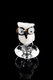 White owl carb cap close-up on reflective black; worked glass accessory for B2B buyers, wide eyes and perch detail shown.