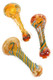 Assorted clear glass spoon pipes with orange and teal twisted spiral accents, decorative worked cane ends, and rounded bowls in multiple color variations.
