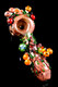 Top-down wholesale photo of 4.5" log-brown glass spoon with ladybugs, orange mushrooms, and vine accents; borosilicate build for head-shop displays.