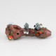 Side profile for B2B listings—log-brown glass spoon, twin owls perched amid vines and orange accents, clean studio white backdrop.