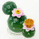 Top-down white studio close-up for B2B listings, showing pink flower accents and raised spine dots on green cactus orbs of the 6" glass mini rig.