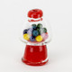 Angled view of red and clear glass gumball bubble cap with colorful spheres inside, white backdrop, listed for head-shop supplies buyers.