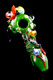 Bright green garden-theme glass spoon for head-shop buyers, 4.5" with ladybug, snail, and flower marbles, angled top view on glossy black backdrop.
