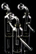 Three 4" clear glass bottle oil burner bubbler rigs on black, globe heads with grommet seals; US-made piece for smoke-shop wholesale buyers.