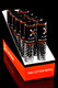 Bulk wholesale display of 12 Flux tar cutter refill tubes in angled orange counter box on black background
