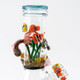 Close detail of reef scene on 8.5" mini beaker: clownfish, octopus arm and coral around neck; premium retail smoke gear, white studio angle.