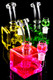 Colorful fluid-filled cube water pipes on black background; pink, yellow, green variants; 14.5 mm joints shown; retail smoke-shop product group, close view.