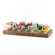 Display loaded with assorted 14.5 mm novelty bowls on clear ground joints; Empire-branded wood stand for retail smoke gear merchandising, front angle.