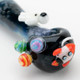 Angled closeup of galaxy bowl showing planet marbles, rocket applique, and glossy black rim; astronaut accent visible, retail smoke gear listing shot.