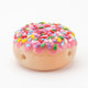 Donut hand pipe on white with bright multicolor sprinkles and side carb; compact borosilicate design for B2B smoke-shop listings, front three-quarter view.
