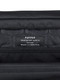 Interior Puffco brand tag close-up inside black bag; quilted lining texture, B2B accessory detail.