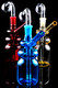 5.5" glass-on-glass bottle oil burner rigs in blue, red, and amber with clear domes on glossy black—wholesale head-shop trio, front angle.