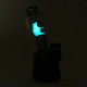 UV-lit side profile on Peak base highlighting turquoise glow and exhaust detail; glass attachment photographed for wholesale catalog.