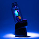 High-contrast three-quarter view on Peak base showing luminous body and fins; worked glass accessory for retail smoke cases.