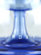 Close-up of Sea blue Ripple base showing “PROXY” lettering; stable ripple pedestal detail for wholesale head-shop display, macro angle. Close-up of Sea blue Ripple base showing “PROXY” lettering; stable ripple pedestal detail for wholesale head-shop display, macro angle.