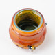 Top-down detail of Honeycomb Terp Jar opening showing green interior swirl and bee accent—borosilicate concentrate jar for head-shops.