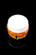 Studio shot on black of Honeycomb Terp Jar sealed with white screw-top lid, amber drip texture and bee detail—wholesale display image.