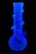 Glow-in-the-dark 10" soft-glass round base GoG water pipe with spiral wrap, shown under black light; great head-shop display piece for holiday promos.