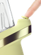 Retail smoke gear Puffco New Peak Zest e-rig close-up with finger pressing the yellow Joystick Cap