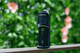 Dr. Dabber Switch GO displayed outdoors on a railing with front buttons, glass top, and colored light arc