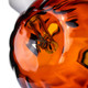 Close-up through orange Jack O'Ripper pumpkin glass showing the internal glass pathway and MJ Arsenal logo