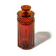 Angled view of amber NWTN Highball glass gravity bong with geometric shell and textured top for retail smoke gear displays.
