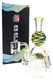 6B Glass dab rig with green mouthpiece, multicolor zigzag neck, clear banger, and branded box.