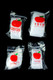 bulk wholesale Apple Bags four-size clear mini baggie bundles with red apple logo on black studio backdrop