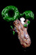 Green-canopy tree trunk glass spoon with white squirrel accent on glossy black—wholesale head-shop hand pipe, compact 4" novelty design.