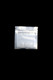 Wholesale 3-inch by 3-inch half-gram mylar bag, clear front with black back, resealable zip closure, centered on black background overhead view