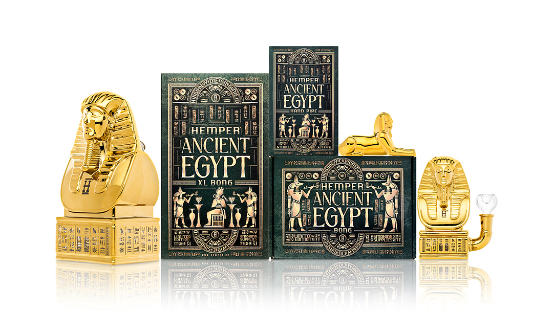 Hemper Ancient Egypt gold pharaoh themed glass hand pipe, bong and XL bong family with hieroglyph packaging