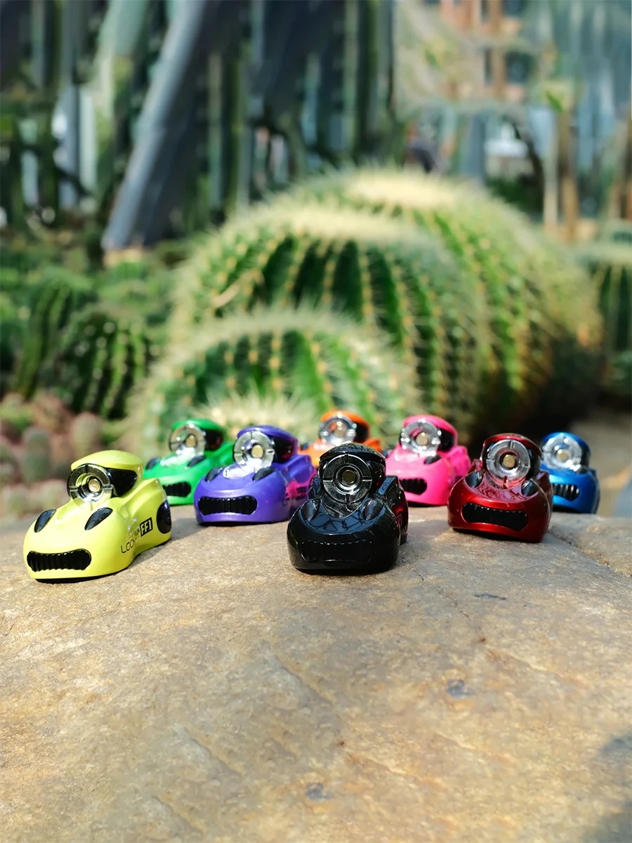 Lookah FF1 miniature race-car 510 batteries in assorted colors lined up outdoors on rock