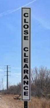 Aldon 4015-62 Vertical Safety Sign on a steel post