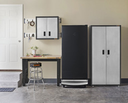 Gladiator 17.8 Cu. Ft. Upright Freezer in garage setting next to workbench and Gladiator cabinet with door closed