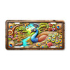 Rustic peacock license plate with jewel-toned feathers, floral accents, and scenic river background on aluminum.