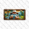 Meadow Gnome license plate featuring smiling copper-toned gnome holding daisies, set against meadow, wildflowers, and mountain backdrop in rustic embossed-look style.