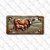 Mama cow and calf license plate featuring rustic barnyard design with field, barn, and leaf accents in warm earthy tones.