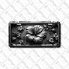 Black and silver hibiscus floral license plate featuring monochrome embossed-look artwork on aluminum.
