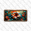 Fiery hibiscus floral license plate featuring bold red, orange, and teal petals against a tropical sunset background in embossed-look artwork on aluminum.