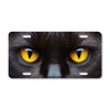 Black cat license plate featuring vivid golden-yellow eyes in striking high-contrast feline design on aluminum.