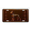 Doberman Pinscher dog license plate featuring a muscular copper-toned Doberman with cropped ears, ornate embossed-look swirls, and paw prints on a rustic aluminum background.