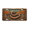 Western rattlesnake license plate featuring coiled snake, desert canyon, and cactus in rustic embossed-look artwork on aluminum.