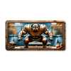 Bulldog football mascot license plate featuring linebacker squat stance with chain-link fence background, rustic embossed-look artwork on aluminum.