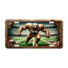 Eagle football mascot license plate featuring copper-toned eagle charging across the field in rustic embossed-look artwork with cracked frame design