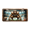 Lion football mascot license plate featuring copper-toned lion crouched in linebacker stance with glowing stadium lights in rustic embossed-look artwork