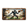 Panther football mascot license plate featuring muscular copper-and-steel-toned panther gripping a football with cracked stadium wall backdrop in rustic embossed-look artwork.