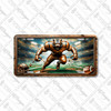 Tiger football mascot license plate featuring a roaring tiger in bronze armor charging forward under stadium lights with cracked turf design, rustic embossed-look artwork on aluminum.