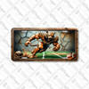Tiger football mascot license plate featuring a roaring tiger in bronze football armor charging across the field with cracked stone wall background, rustic embossed-look artwork on aluminum.