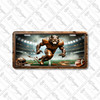 Wolf football mascot license plate featuring a bronze-armored wolf sprinting forward under stadium lights with torn turf effect, rustic embossed-look artwork on aluminum.